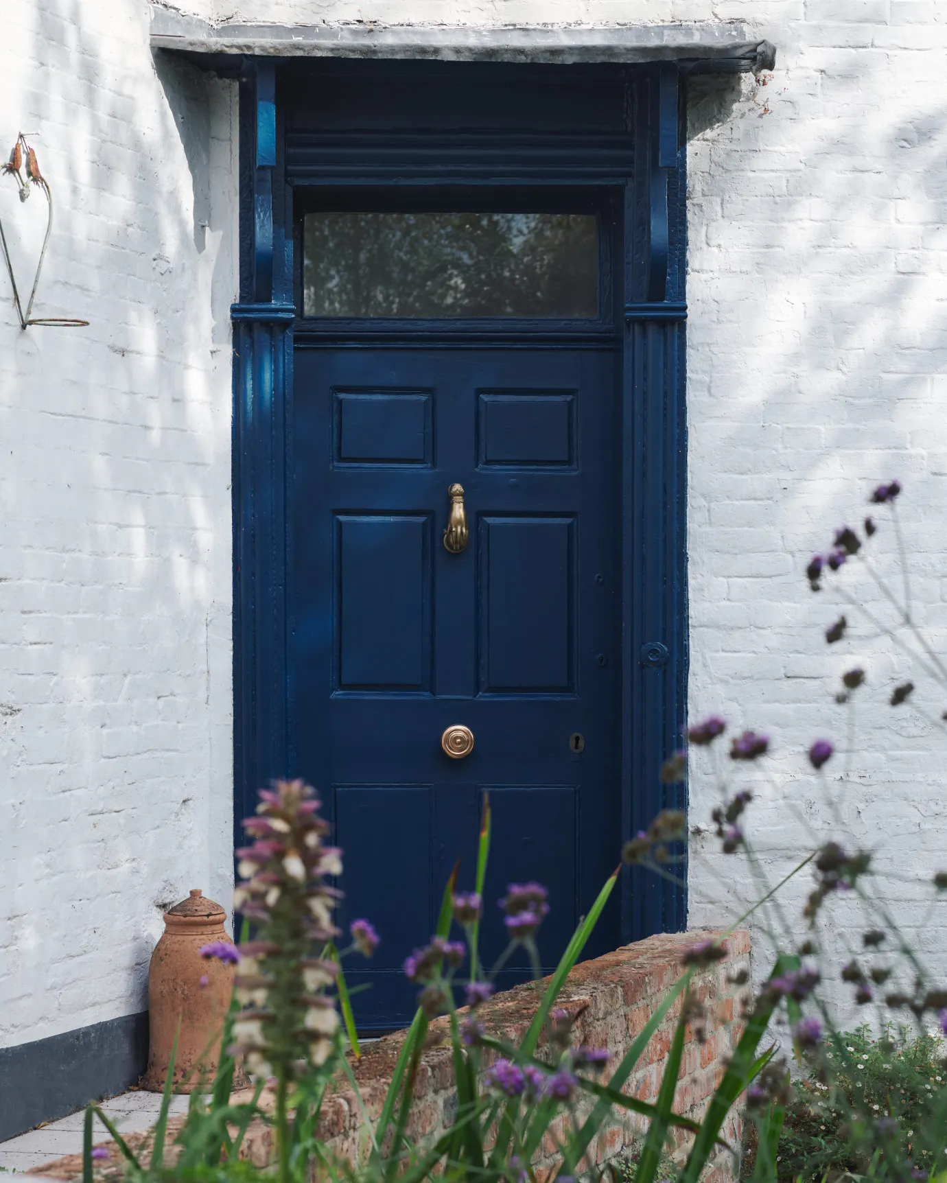 the grand romilly centrepull on a blue wooden door.